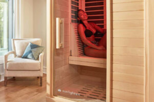 A woman enjoying infrared therapy in a Sunlighten Infrared Sauna